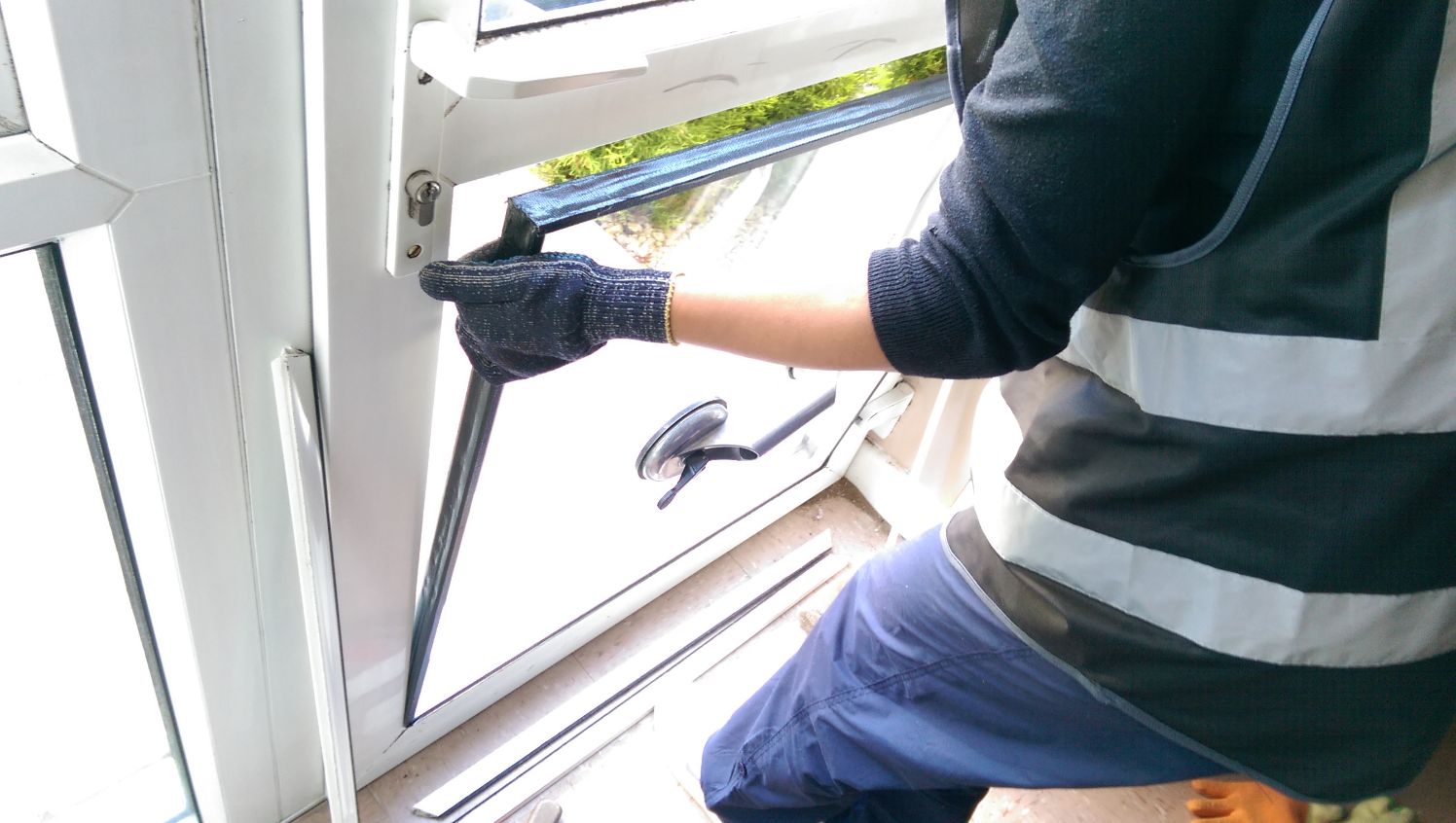 Broken domestic window glass being repaired in London